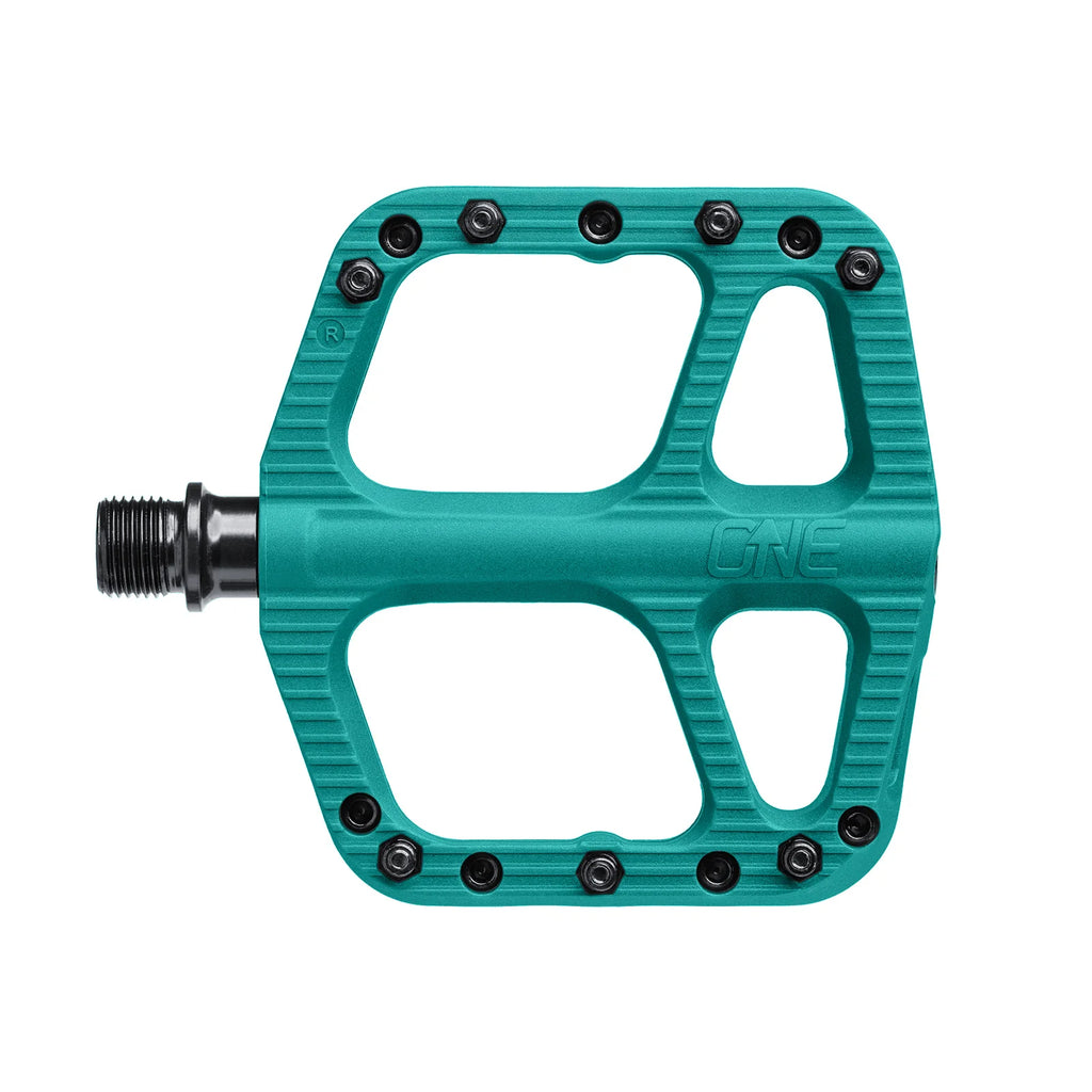 Teal bicycle pedal with 'ONE' branding on a white background