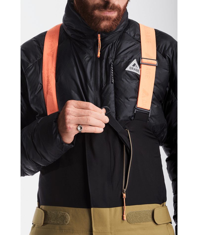Person wearing a black jacket with orange straps on a white background