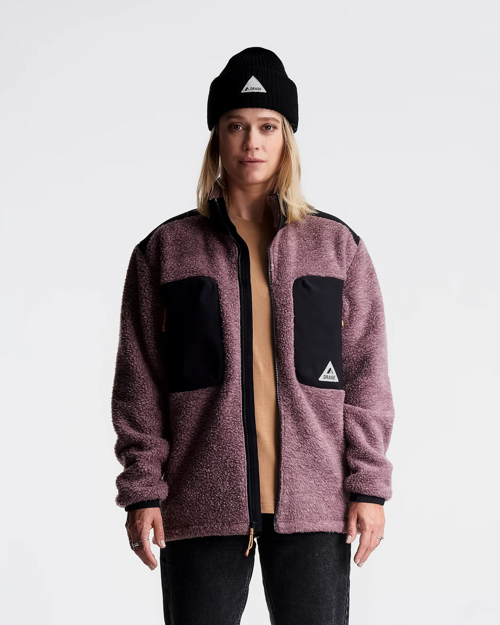Person wearing a maroon fleece jacket with black accents on a white background