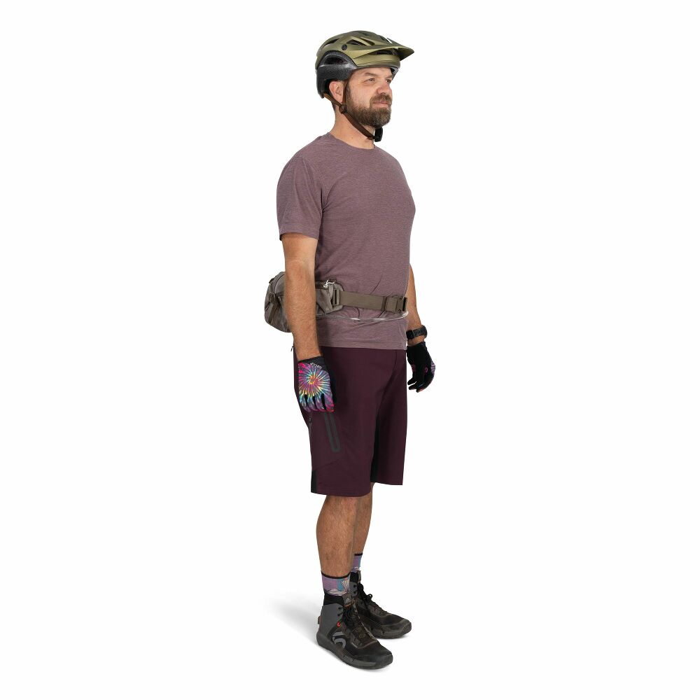 Man wearing a helmet, gloves, and cycling shorts on a white background