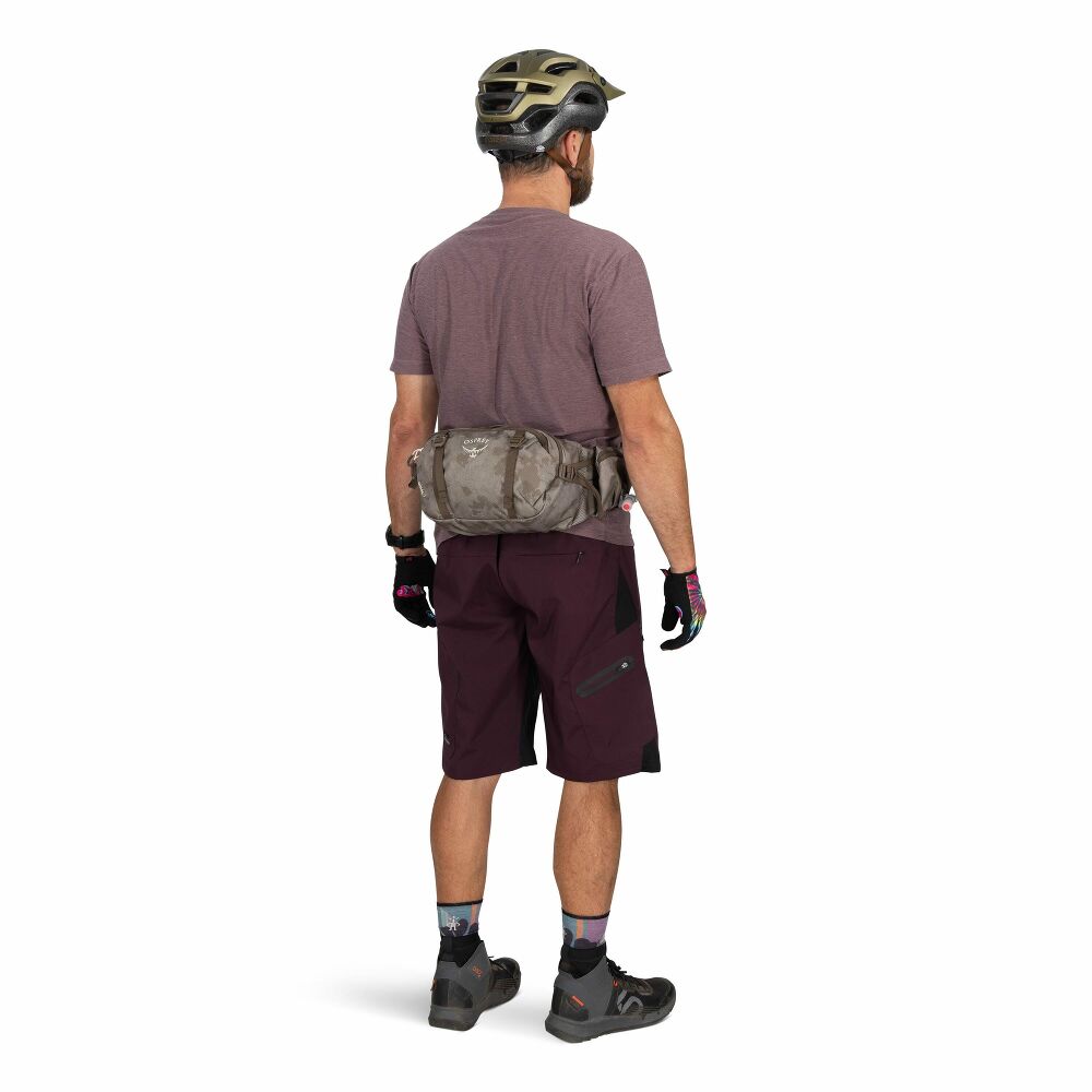 Person wearing a helmet and mountain bike attire on a white background