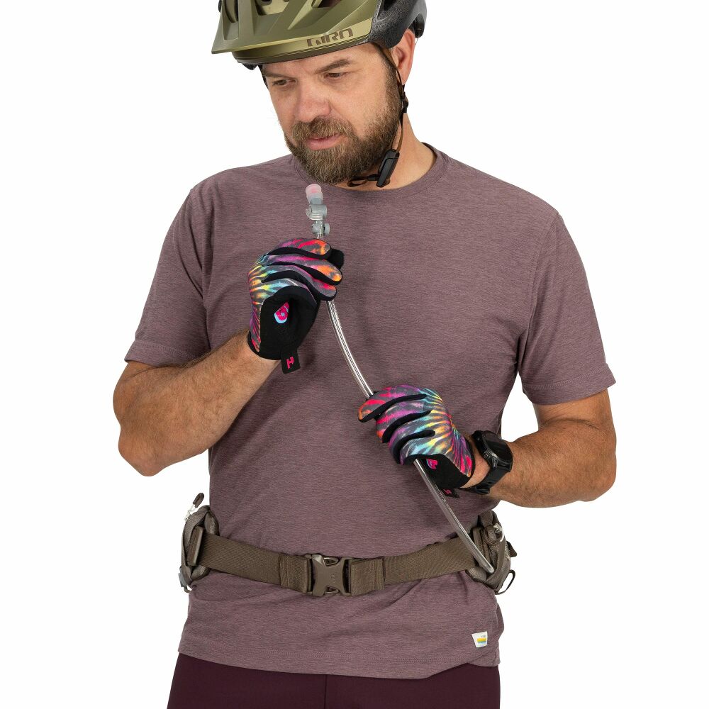 Man wearing a helmet, gloves, and a t-shirt holding a tube on a white background