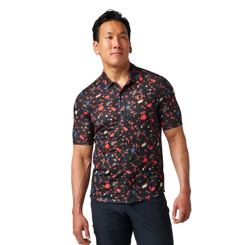 Man wearing a patterned shirt on a white background
