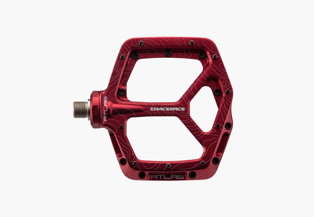 Red bicycle pedal with 'RACEFACE' branding on a white background