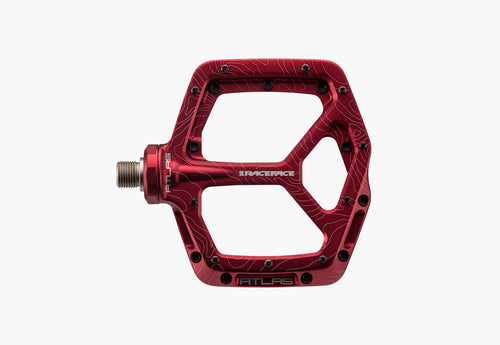 Red bicycle pedal with 'RACEFACE' branding on a white background