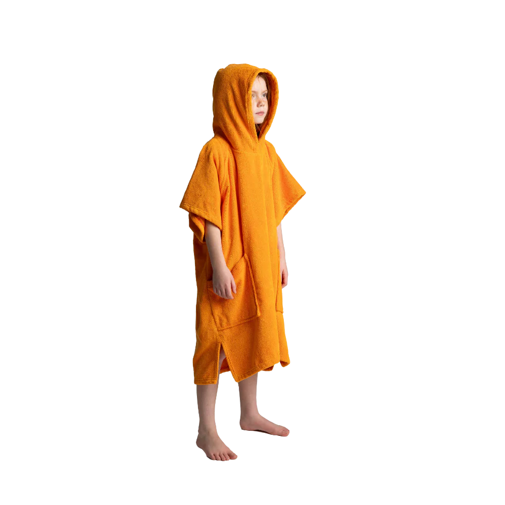 A child wearing a bright orange hooded towel poncho, standing barefoot against a plain white background.