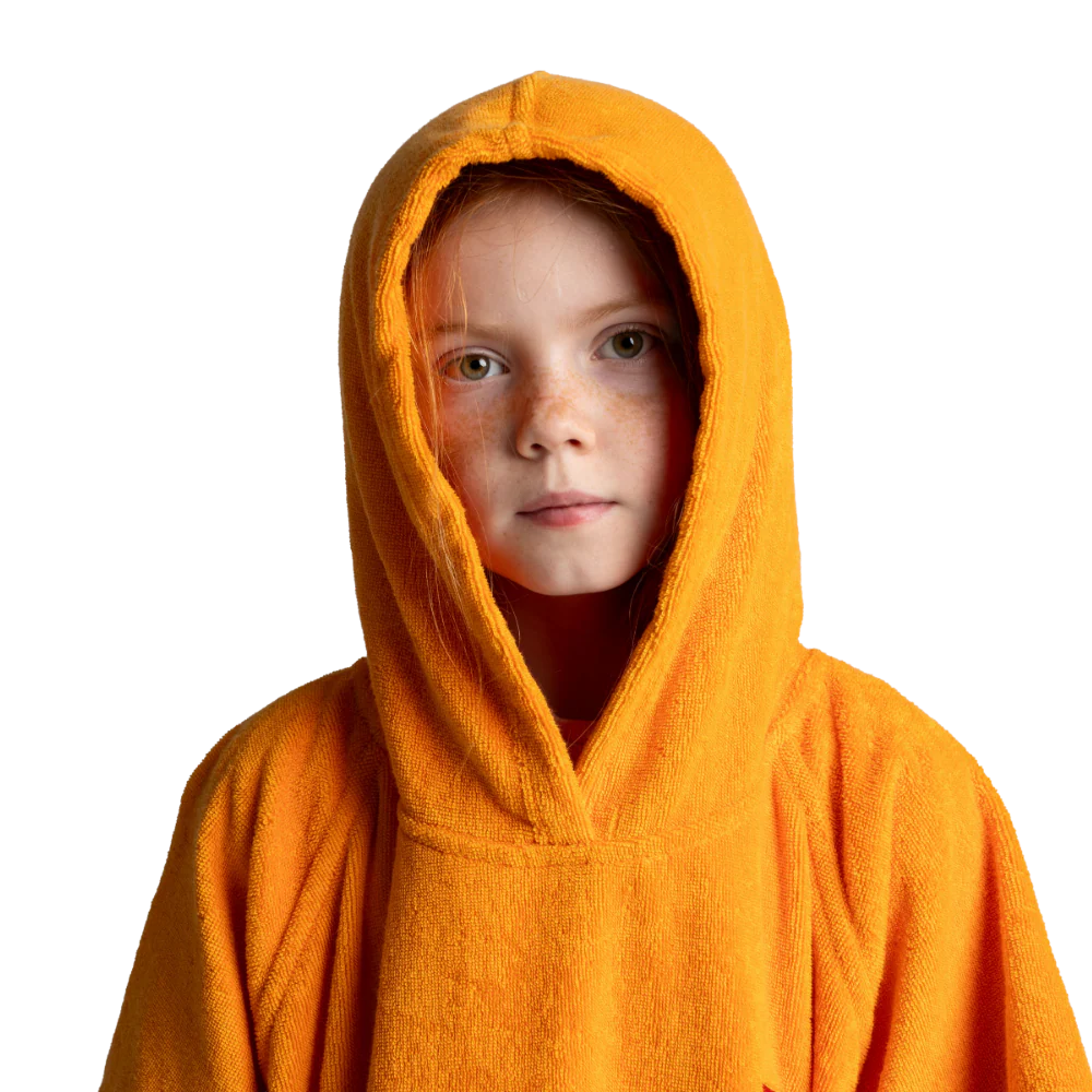 A child wearing a bright orange hooded towel robe, photographed against a plain white background.