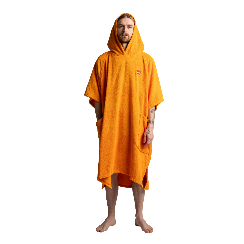 A man wearing a bright orange hooded towel poncho with side pockets, standing against a plain white background.