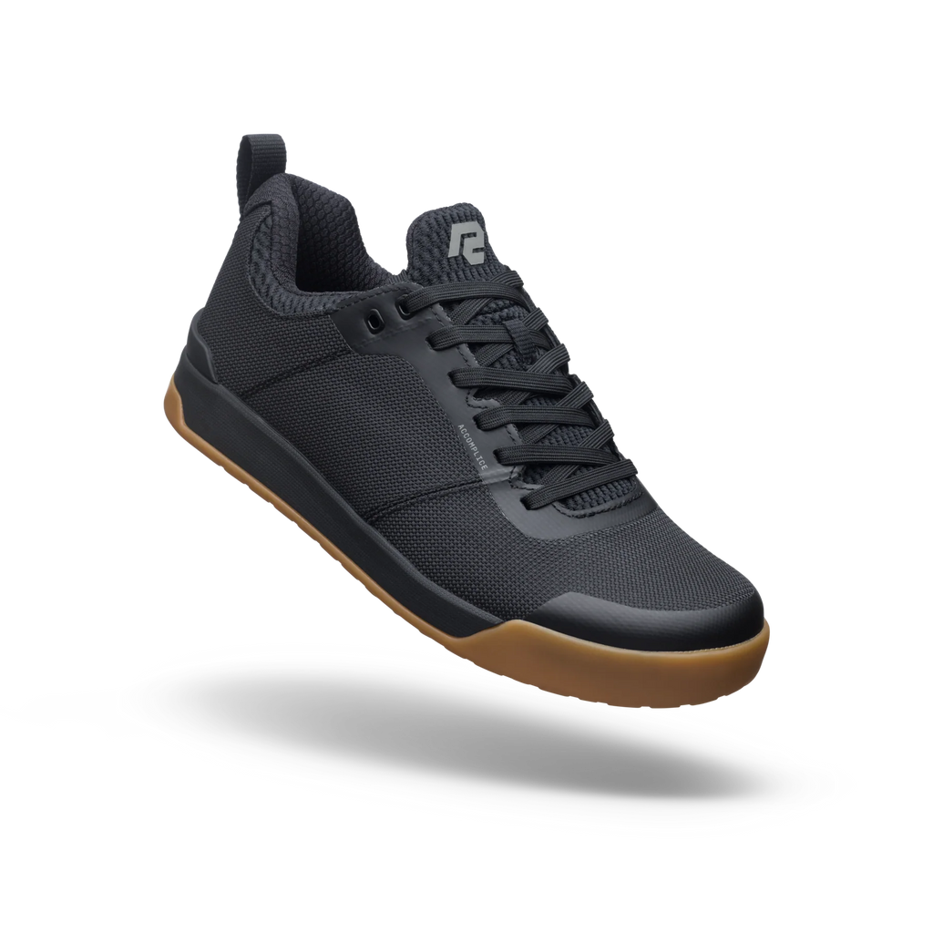 Black sneaker with brown sole on a white background