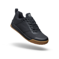 Black sneaker with brown sole on a white background