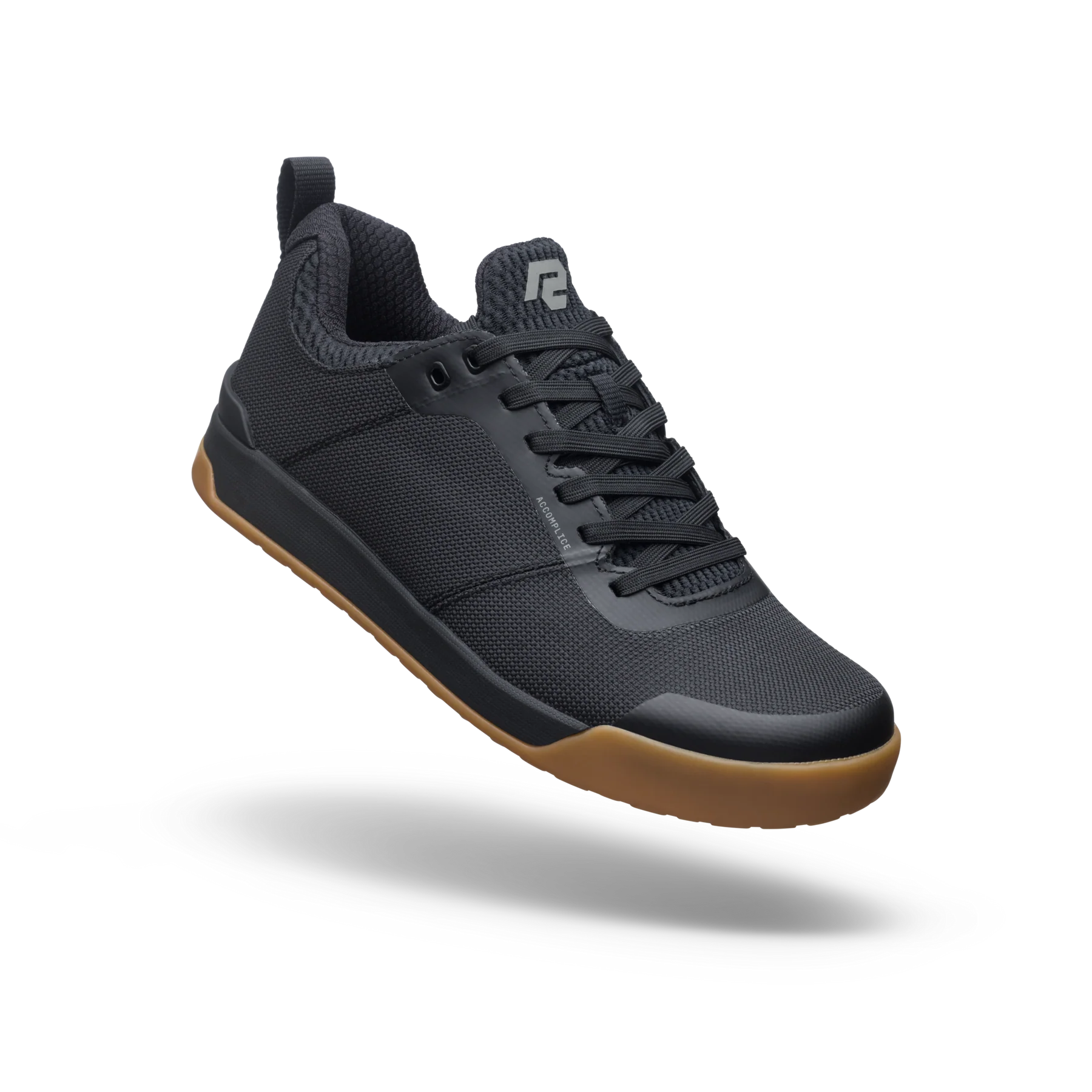 Black sneaker with brown sole on a white background