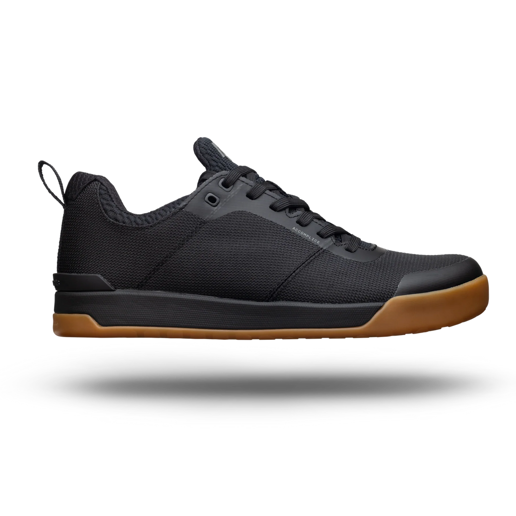 Black sneaker with brown sole on a white background