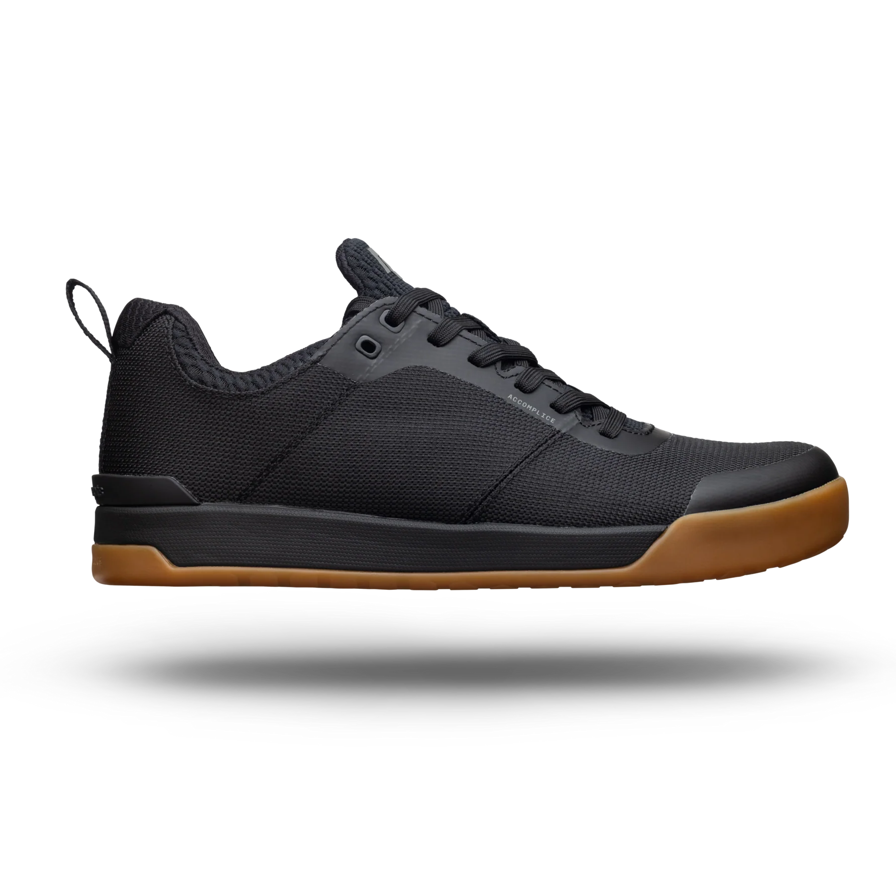 Black sneaker with brown sole on a white background