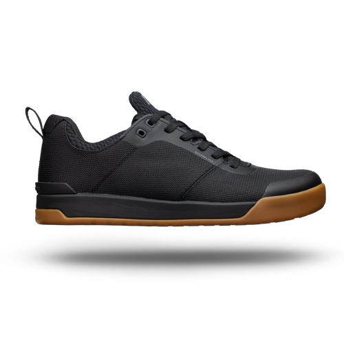 Black sneaker with brown sole on a white background