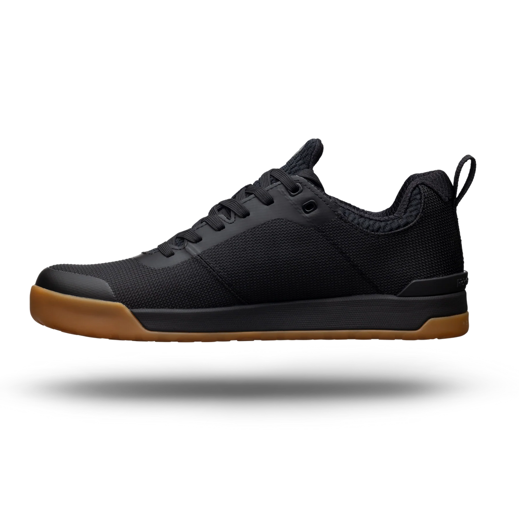 Black sneaker with brown sole on a white background