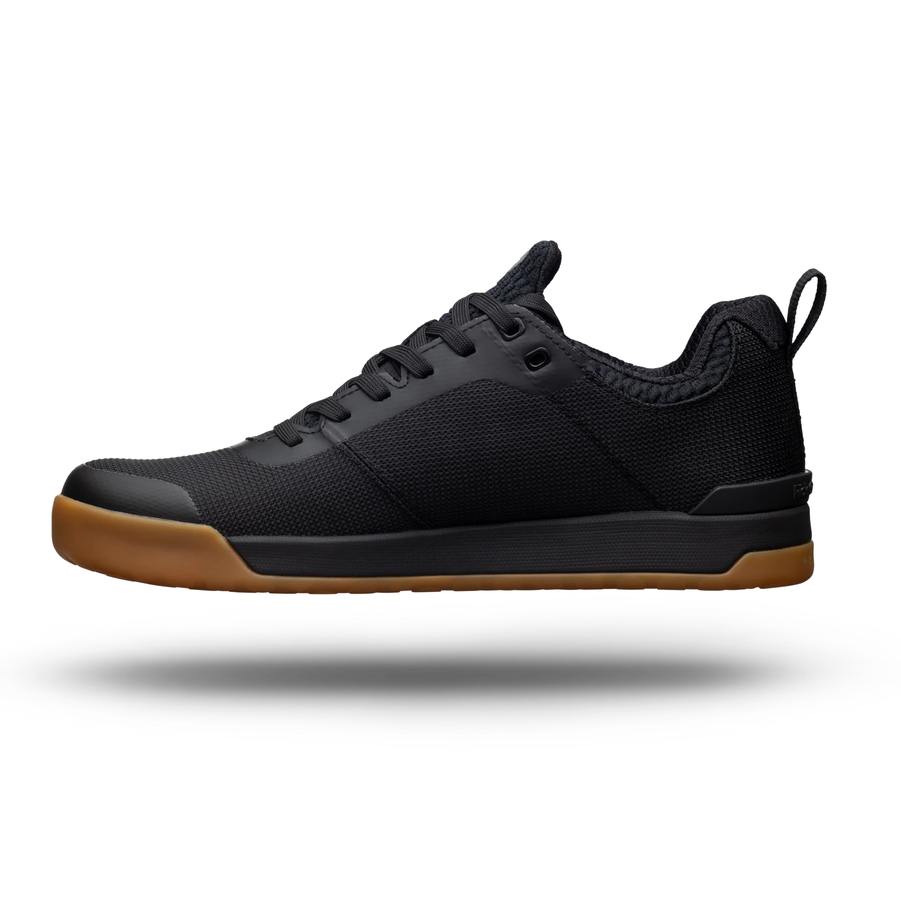 Black sneaker with brown sole on a white background