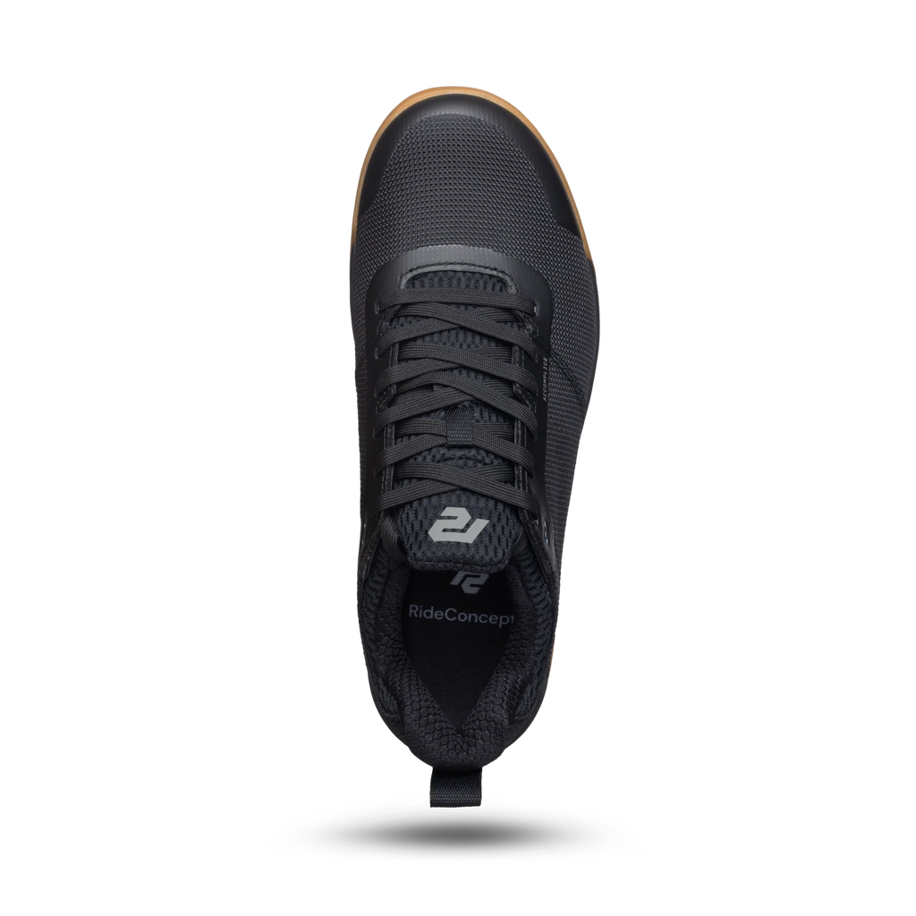 Black sneaker with visible brand logo on a white background