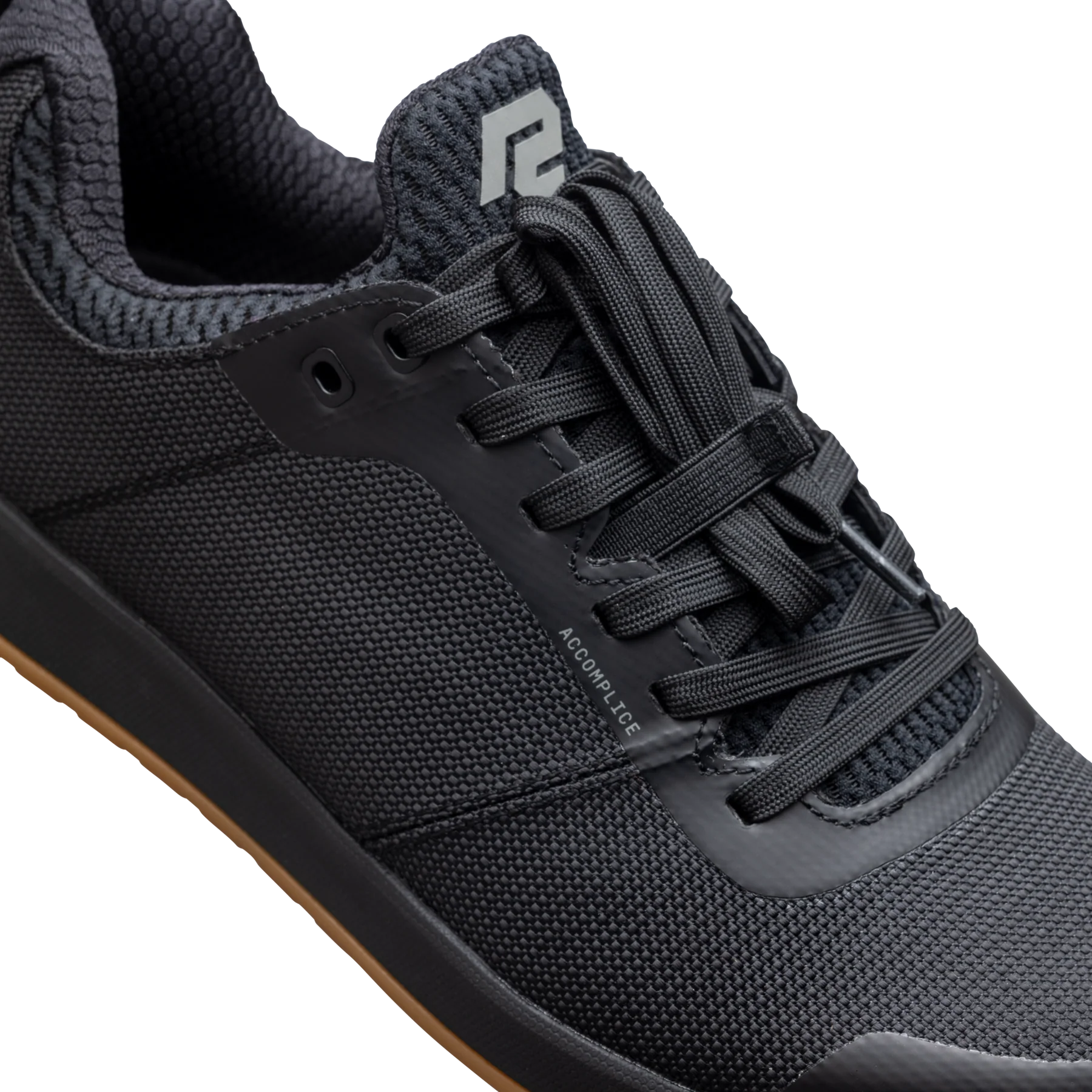 Black athletic shoe with brand logo on a white background