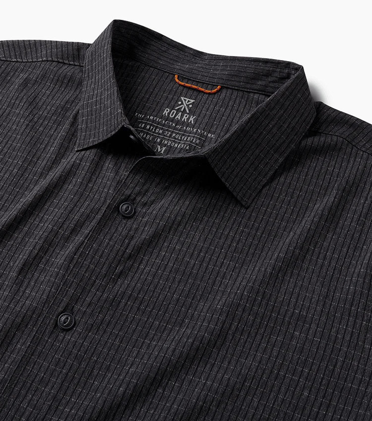 Close-up of a dark gray pinstripe shirt with 'Roark' branding on a white background
