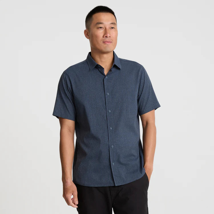 Man wearing a blue checkered shirt against a white background