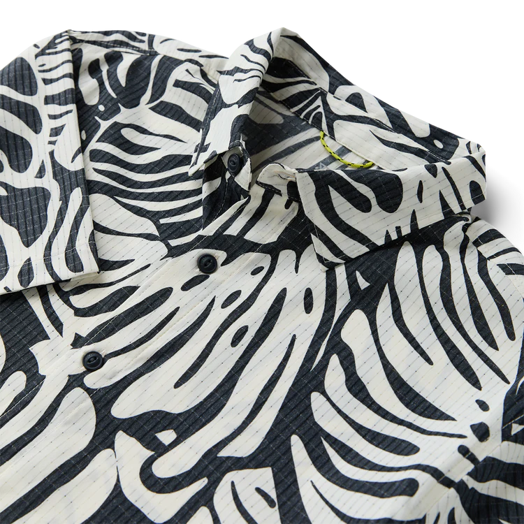 Black and white patterned shirt with a collar on a white background