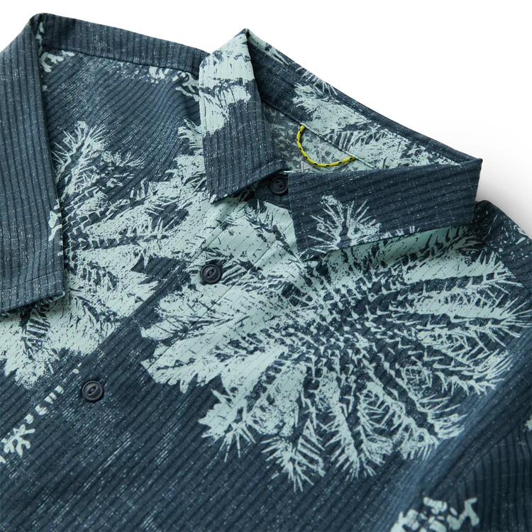 Close-up of a patterned shirt with floral design on a white background