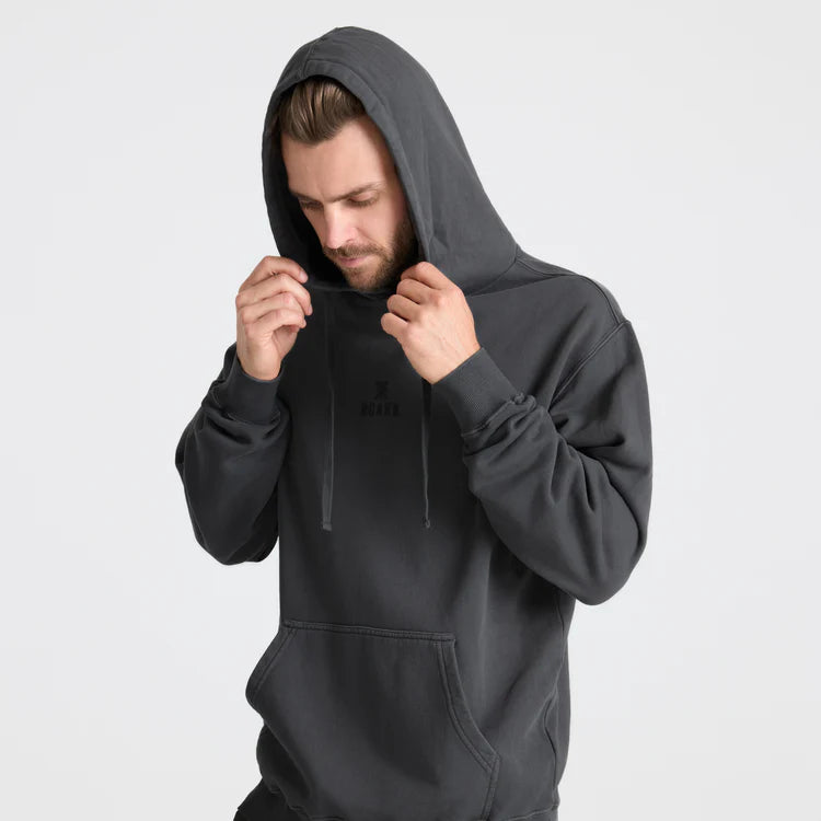 Man wearing a dark gray hoodie on a light gray background