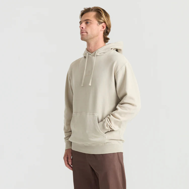 Man wearing a beige hoodie on a light gray background