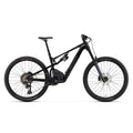 A Rocky Mountain full-suspension mountain bike with a dark teal and black frame, black components, and Maxxis tires, shown from a side profile on a solid white background.
