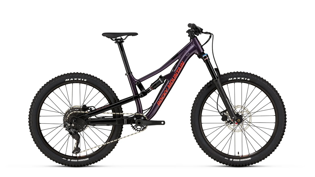 Mountain bike with purple frame and black tires on a white background