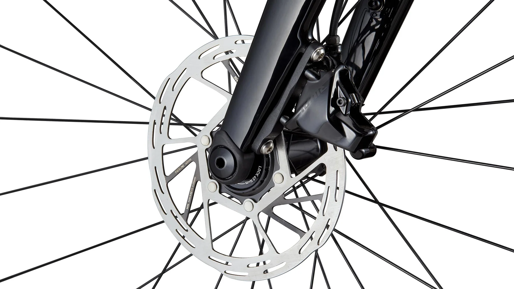 Close-up of a bicycle wheel with disc brake system on a white background