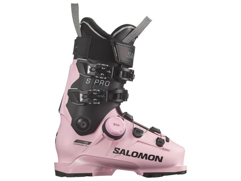 Pink ski boot with black accents and Salomon branding on a white background