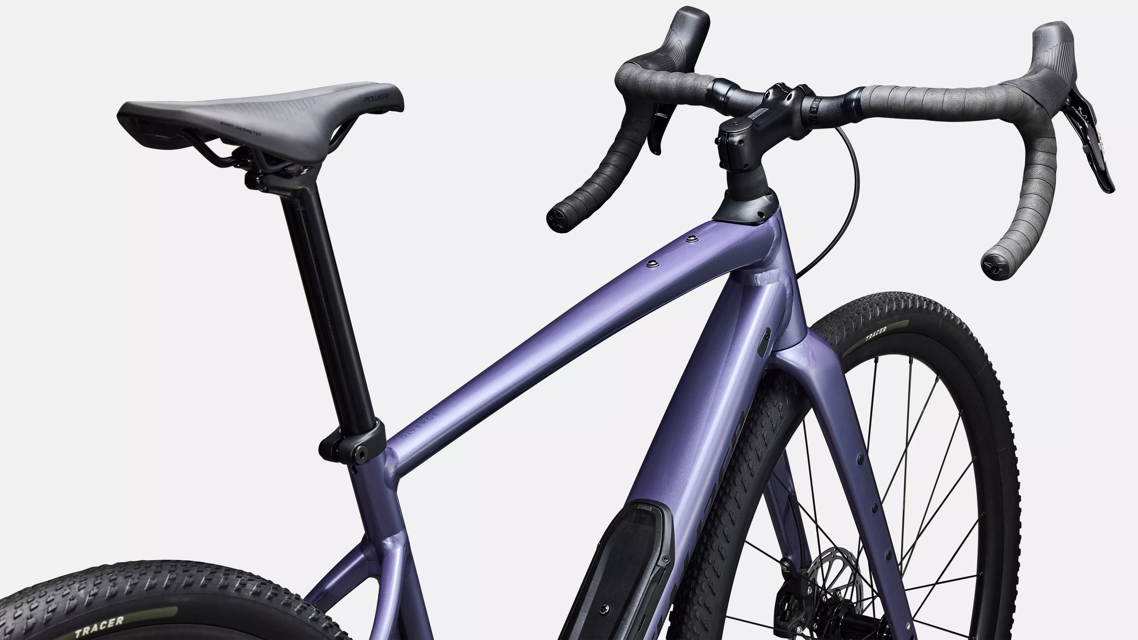 Purple bicycle with black components on a white background