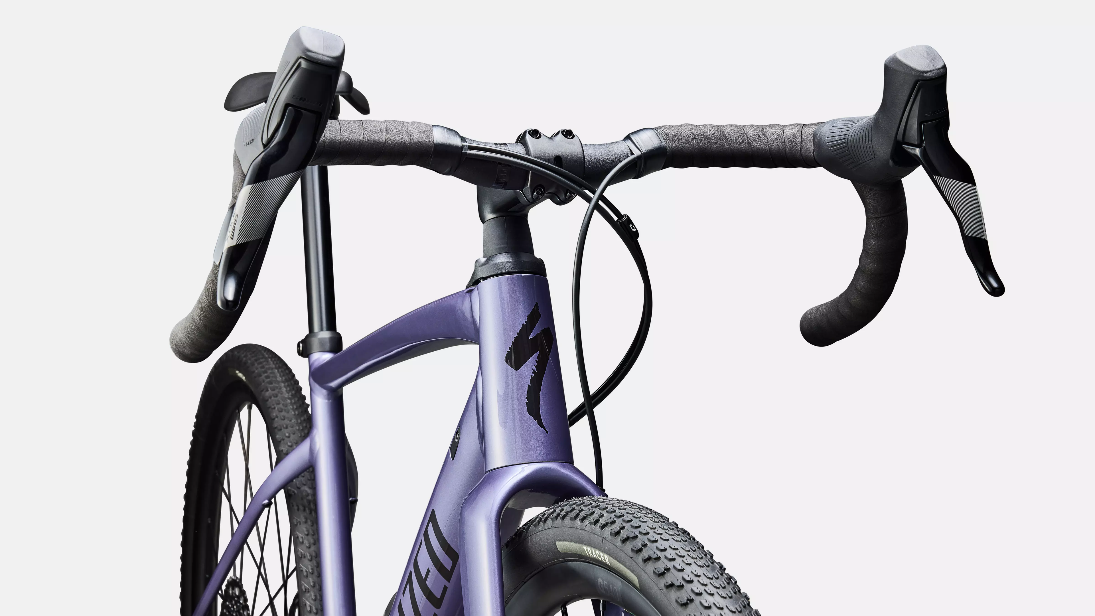 Close-up of a purple bicycle with black handlebars on a white background