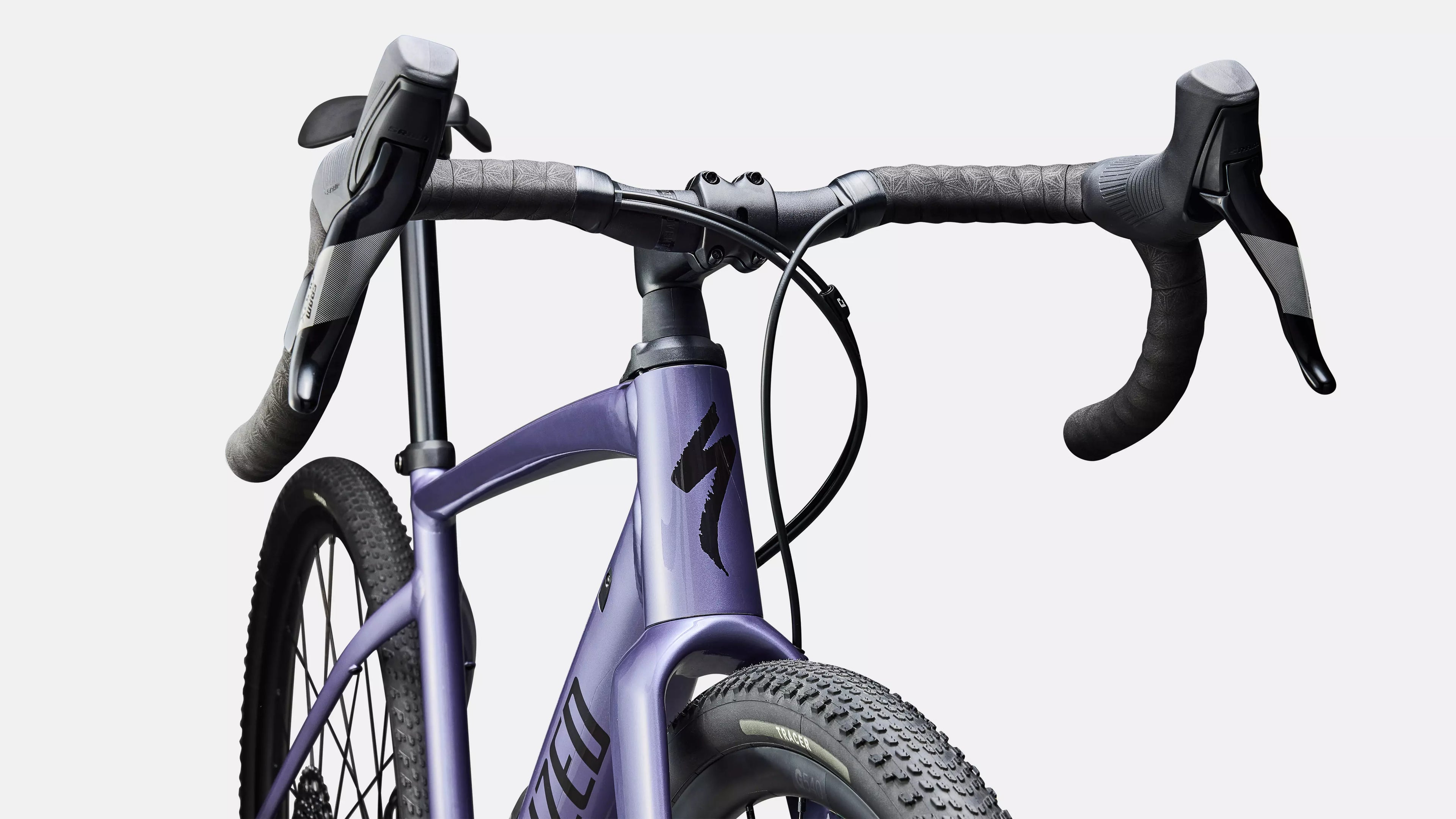 Close-up of a purple bicycle with black handlebars on a white background