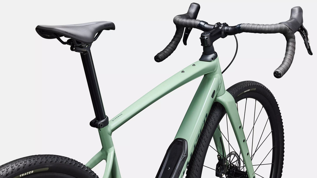 Green bicycle with black components on a light gray background