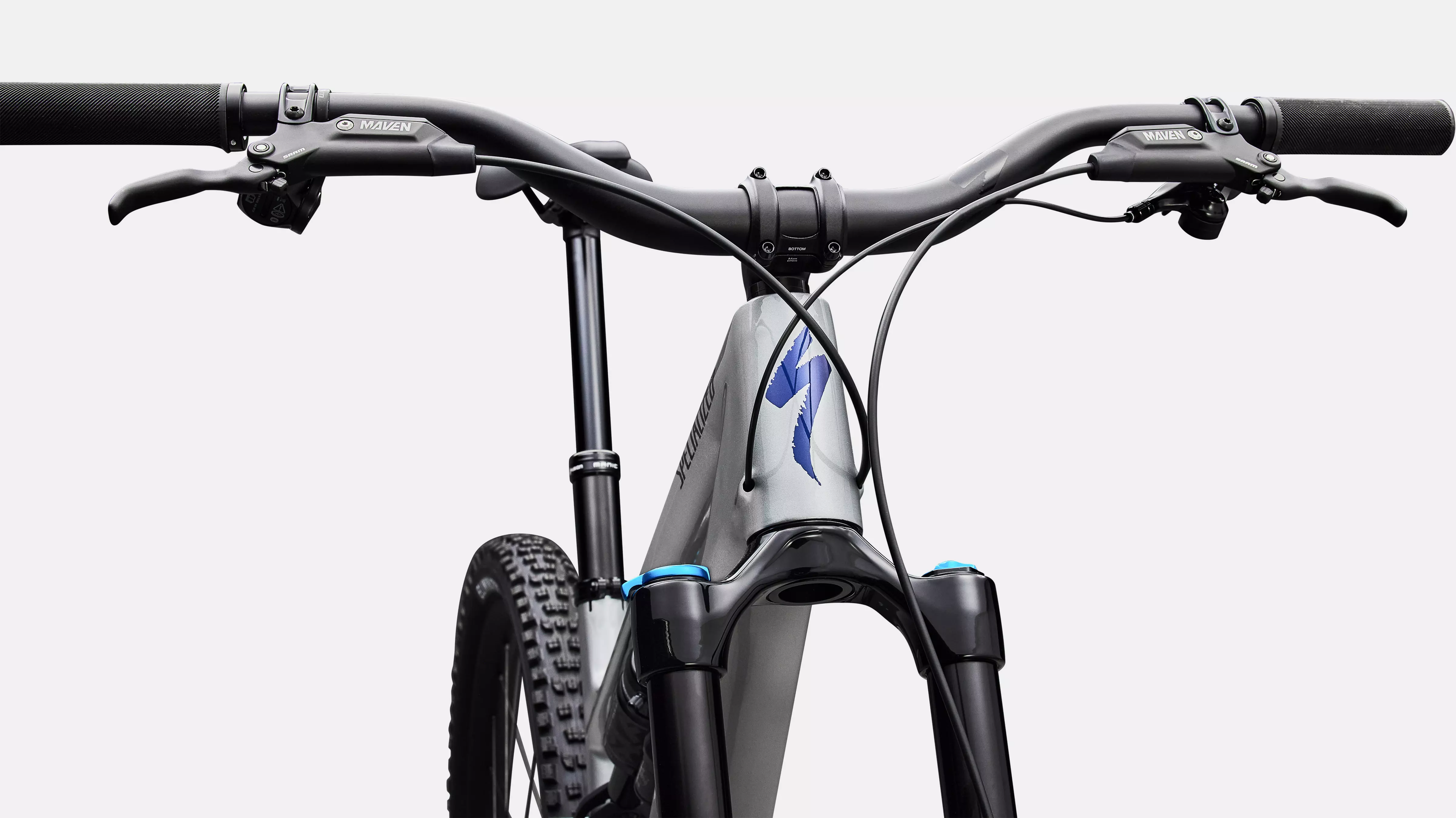 Close-up of a bicycle handlebar with a brand logo on a white background