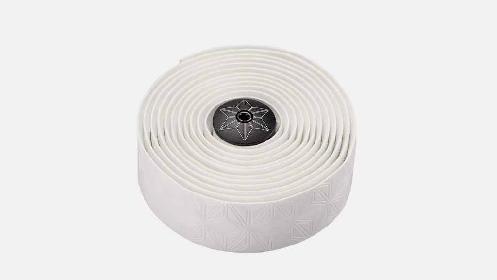 A roll of white bicycle tape with a subtle geometric pattern and a black center cap featuring a white star logo, set against a plain light gray background.