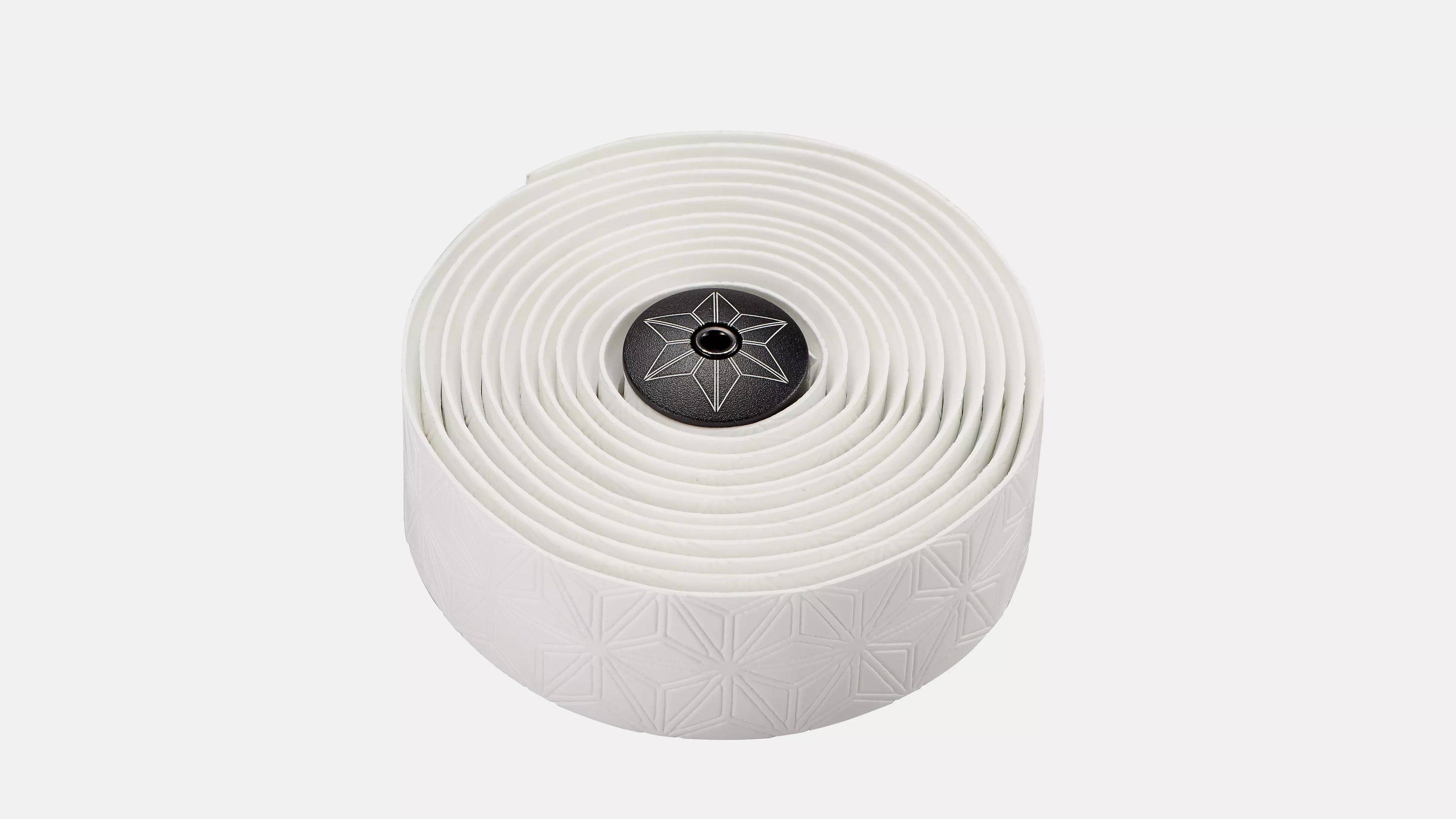 A roll of white bicycle tape with a subtle geometric pattern and a black center cap featuring a white star logo, set against a plain light gray background.