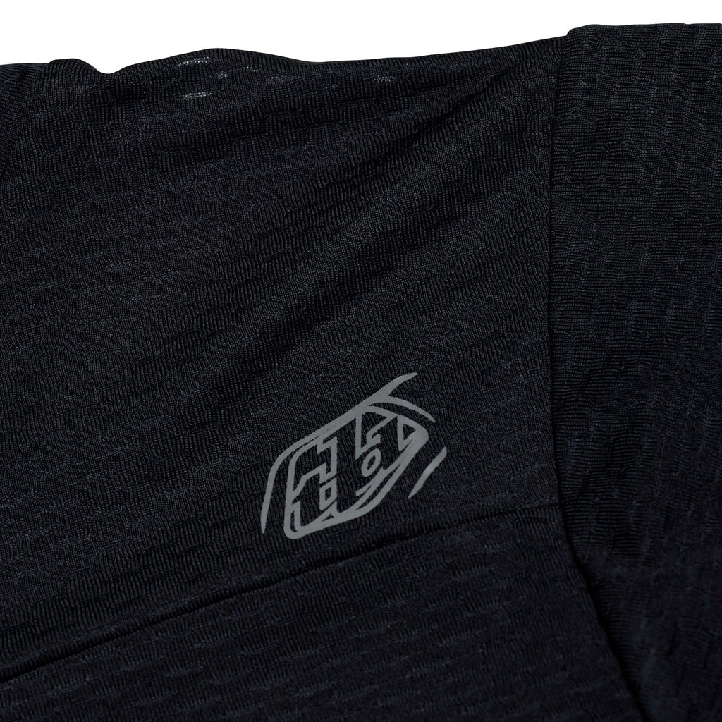 Black t-shirt with a logo on the chest against a white background