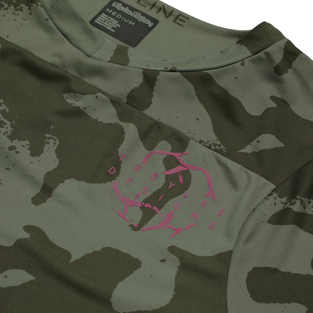 Camouflage t-shirt with pink logo and brand label on a white background