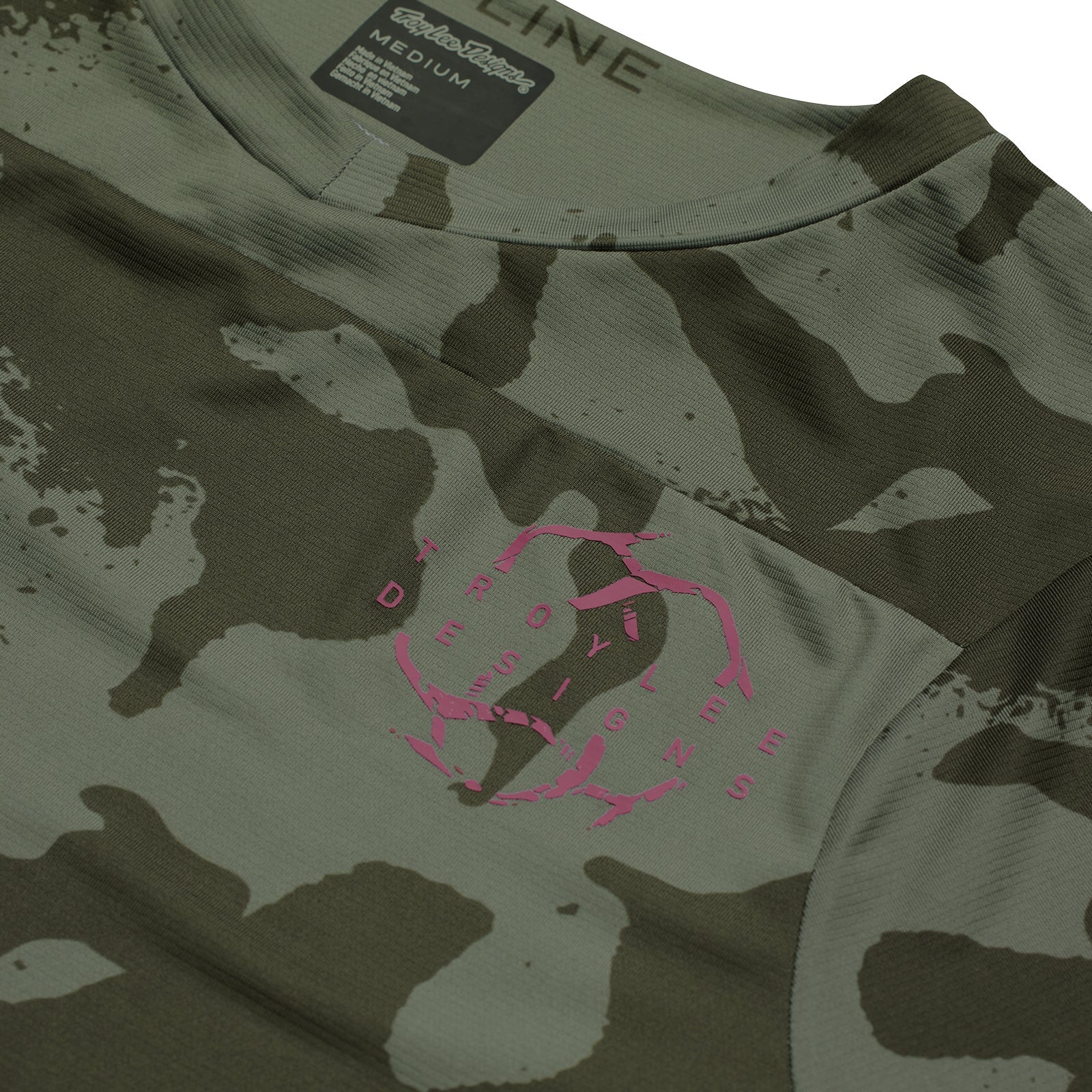 Camouflage t-shirt with pink logo and brand label on a white background