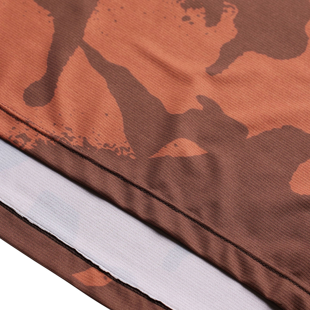 Close-up of a brown camouflage-patterned fabric with a white strip.