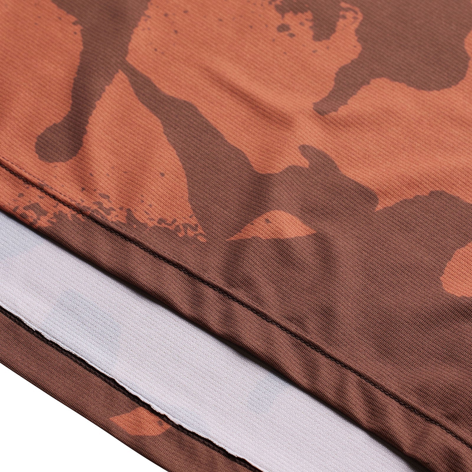 Close-up of a brown camouflage-patterned fabric with a white strip.