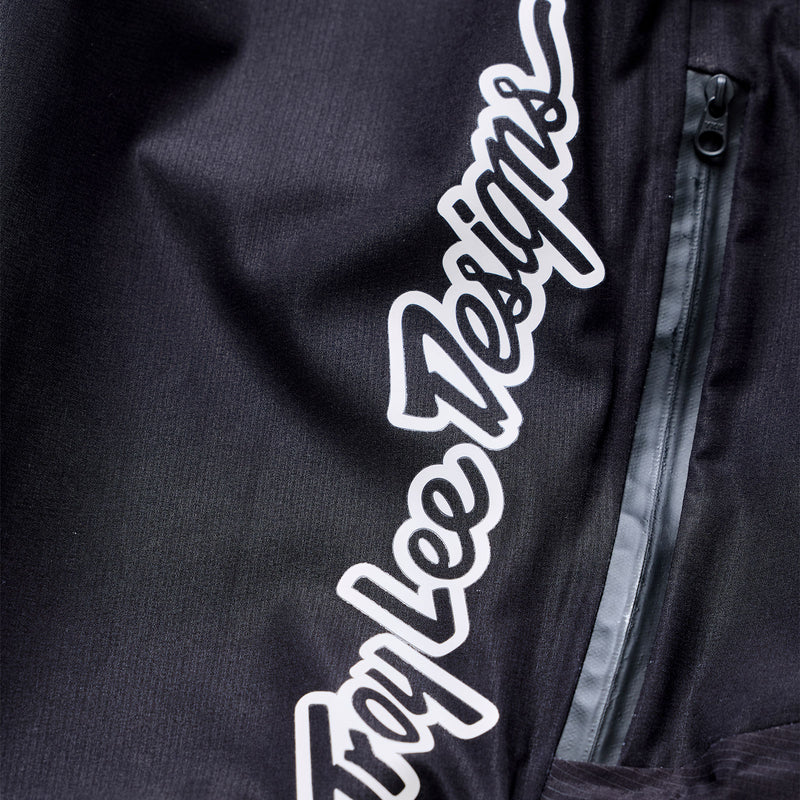 Black jacket with white text logo on a dark background