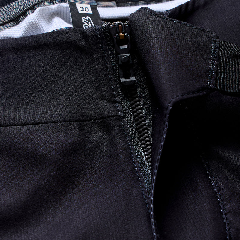 Close-up of a black jacket zipper with brand label