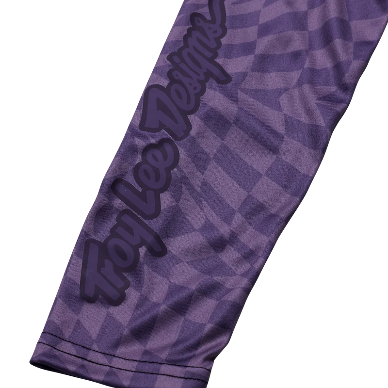 Purple sleeve with checkered pattern and 'Troy Lee Designs' logo on a white background