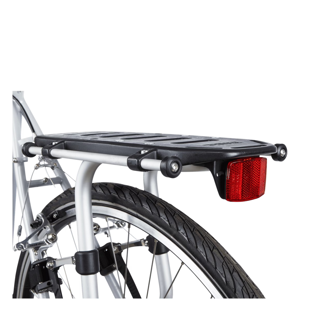 A black bicycle rear cargo rack with a red reflector, mounted on a silver bicycle frame against a white background.