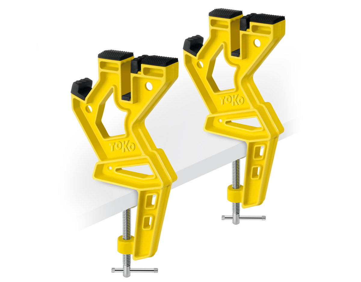 Two yellow clamps on a white background