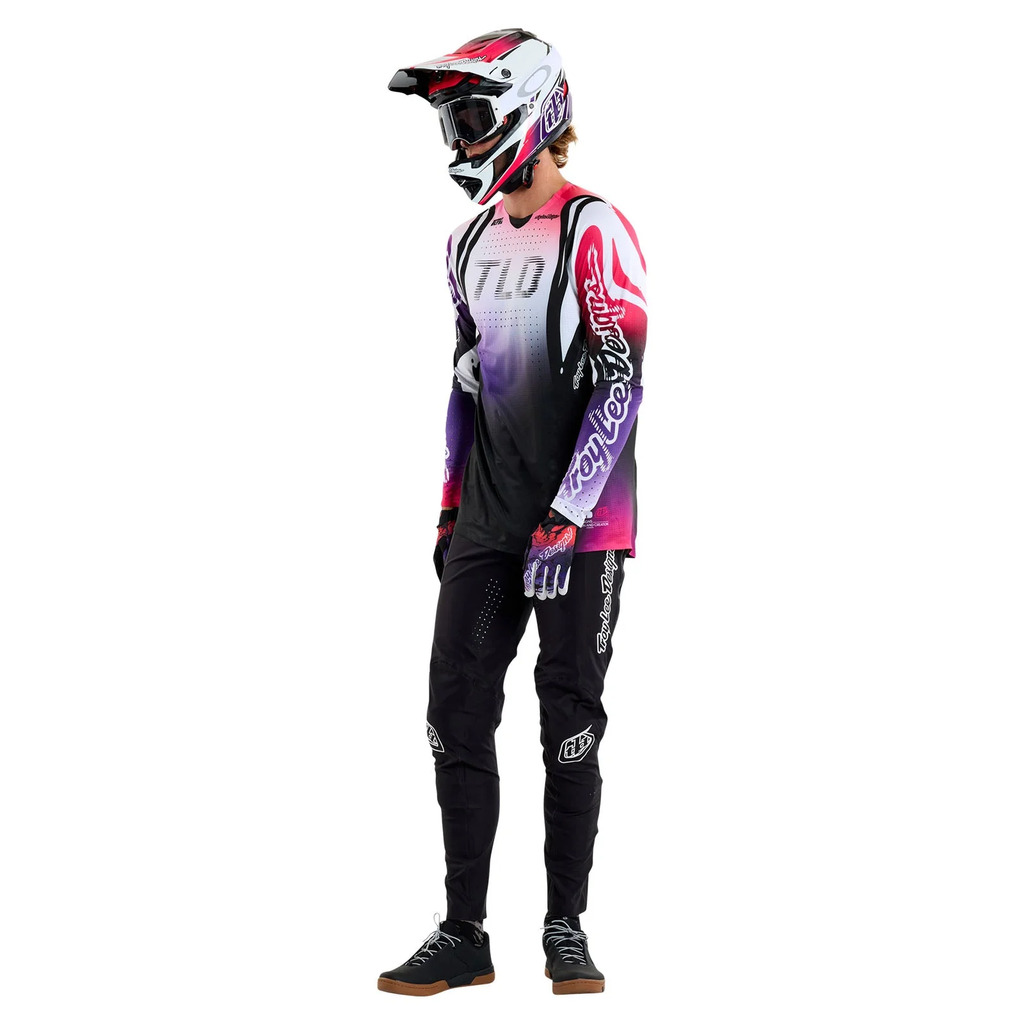 Person wearing a mountain biking outfit with a helmet on a white background